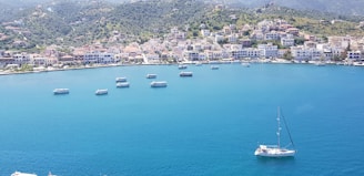 A scenic coastal town with tourists exploring shops and waterfront attractions.