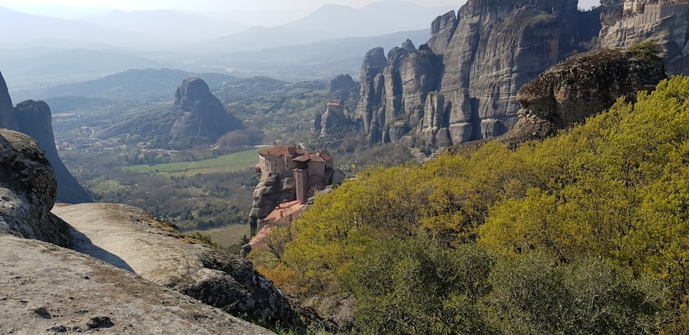 brown concrete building on top of mountain during daytime