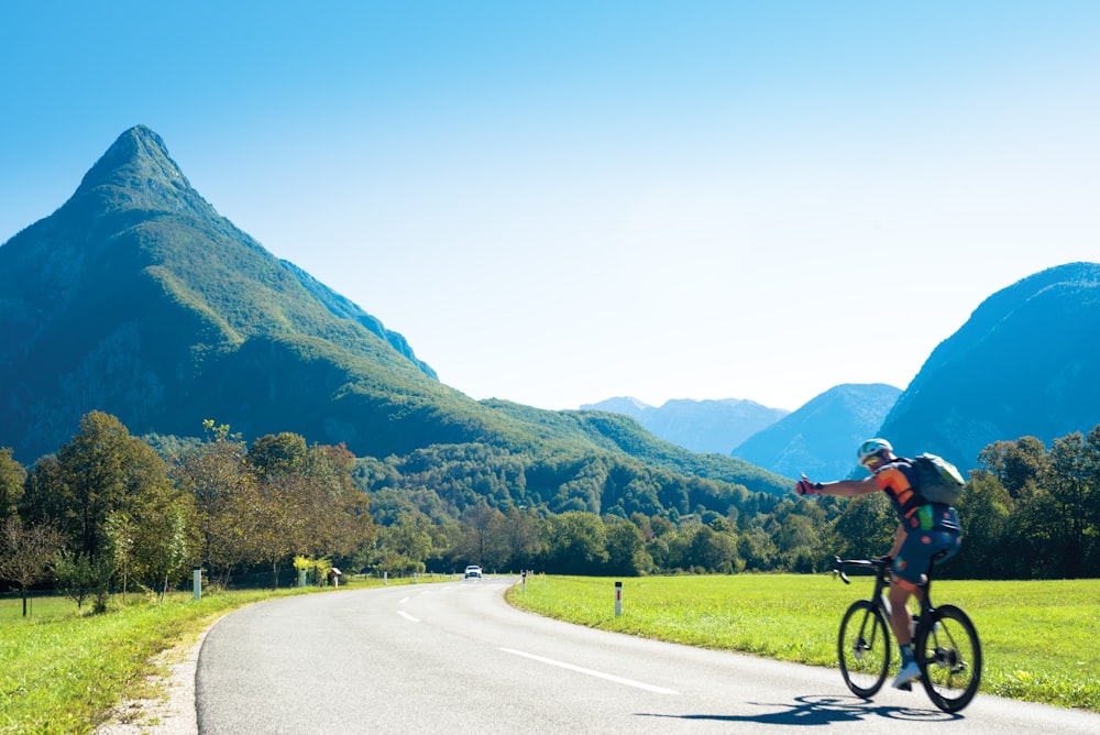 man riding bicycle on road during daytime