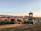 A scenic view of a historic monument in Bucharest on a sunny day.