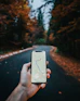 person holding white iphone 5 c