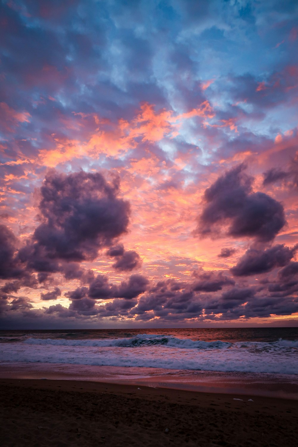 body of water under cloudy sky during sunset