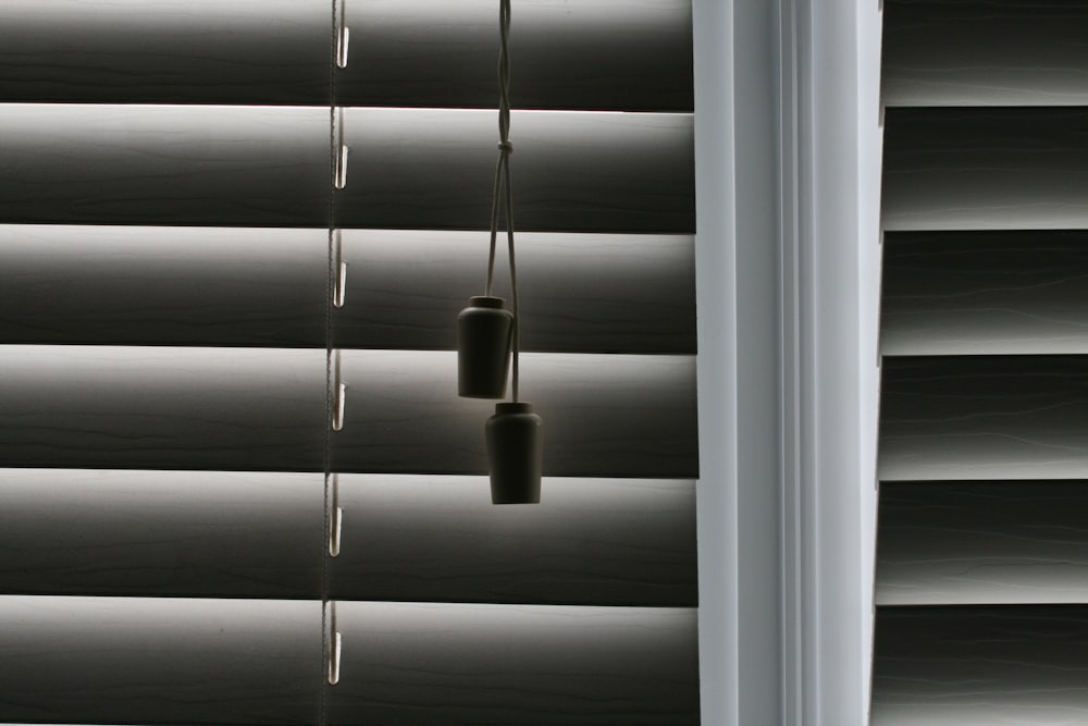 white window blinds with white light bulb
