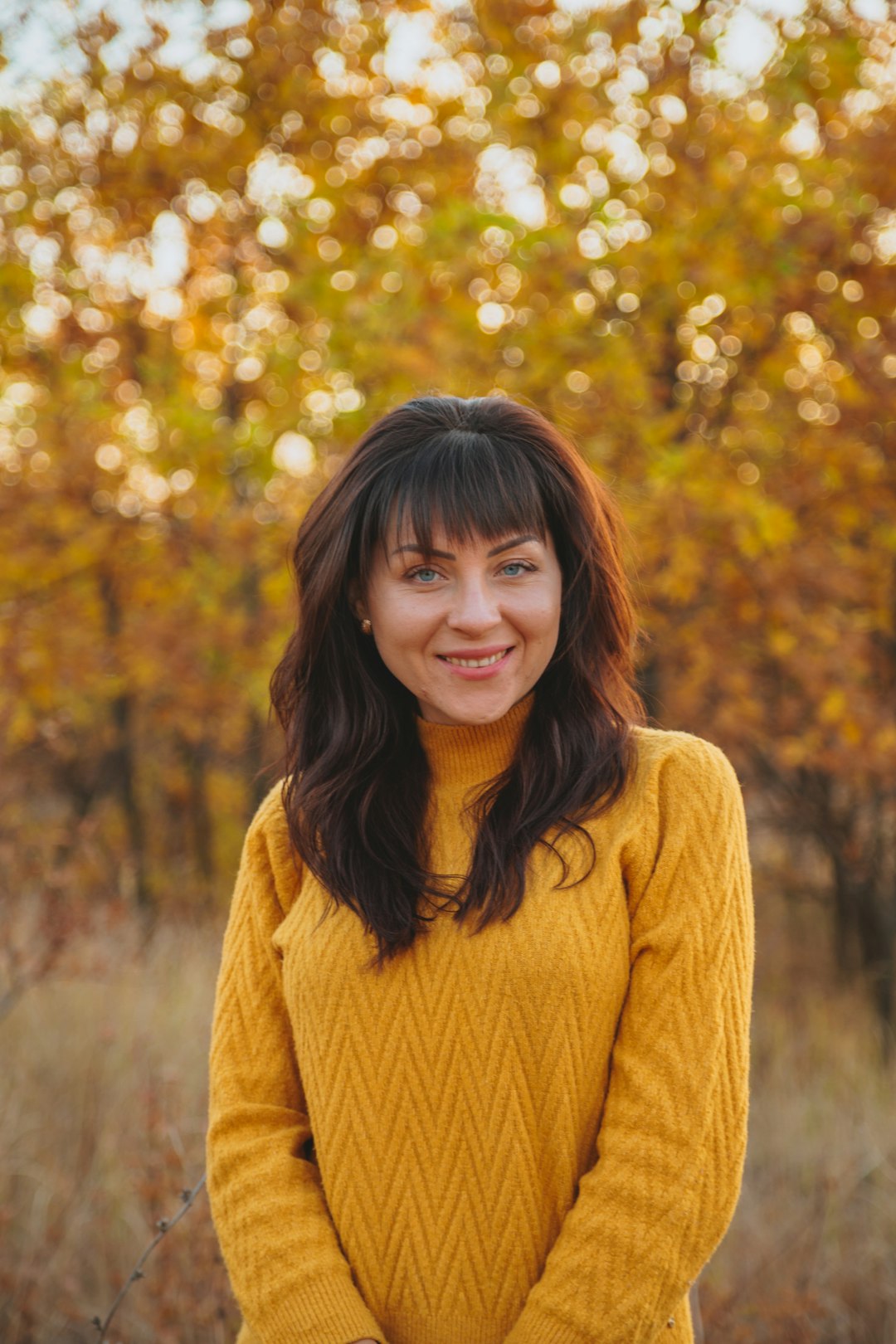 woman in yellow sweater smiling