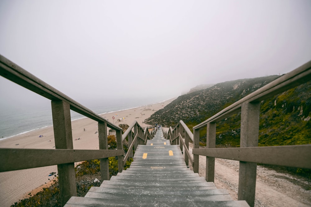 person walking on gray concrete stairs