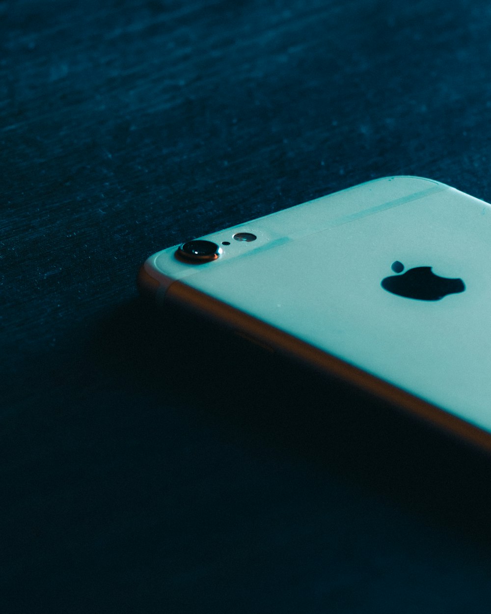 gold iphone 6 on black wooden table