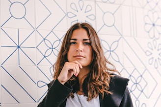 Portrait of a woman with brown hair in a black jacket, highlighting individual journeys