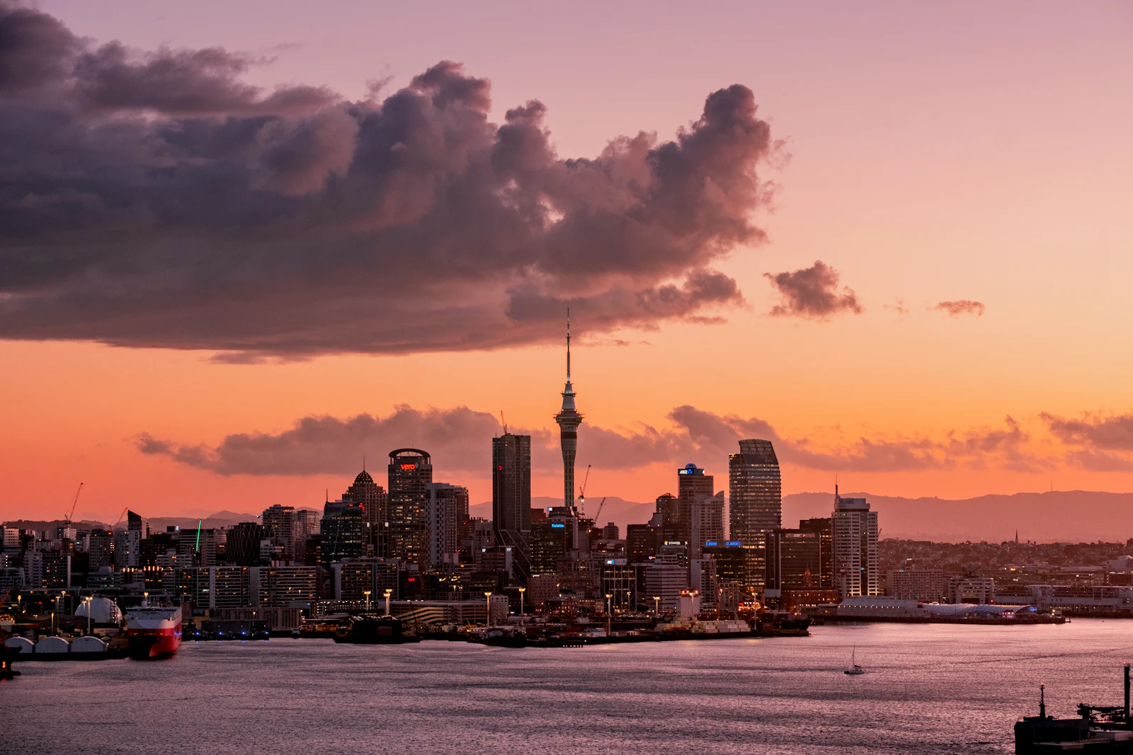Auckland city skyline under a cloudy sky.