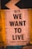 A poster with bold black text reading 'WE WANT TO LIVE' against a backdrop of environmental and social issues listed around the edges. The top features the logo and name 'extinction rebellion.' The design uses contrasting colors and typography to emphasize urgency and activism.