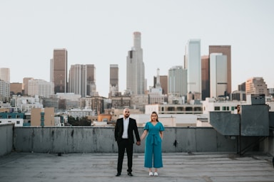 photography poses for couples,how to photograph man and woman standing on gray concrete floor during daytime