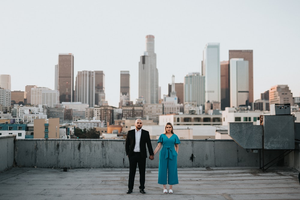 man and woman standing on gray concrete floor during daytime