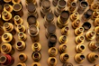 A variety of camera lenses arranged neatly on a rustic wooden surface.