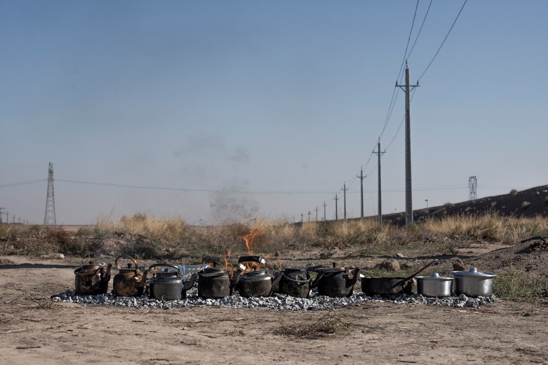 black fire pit on brown field during daytime