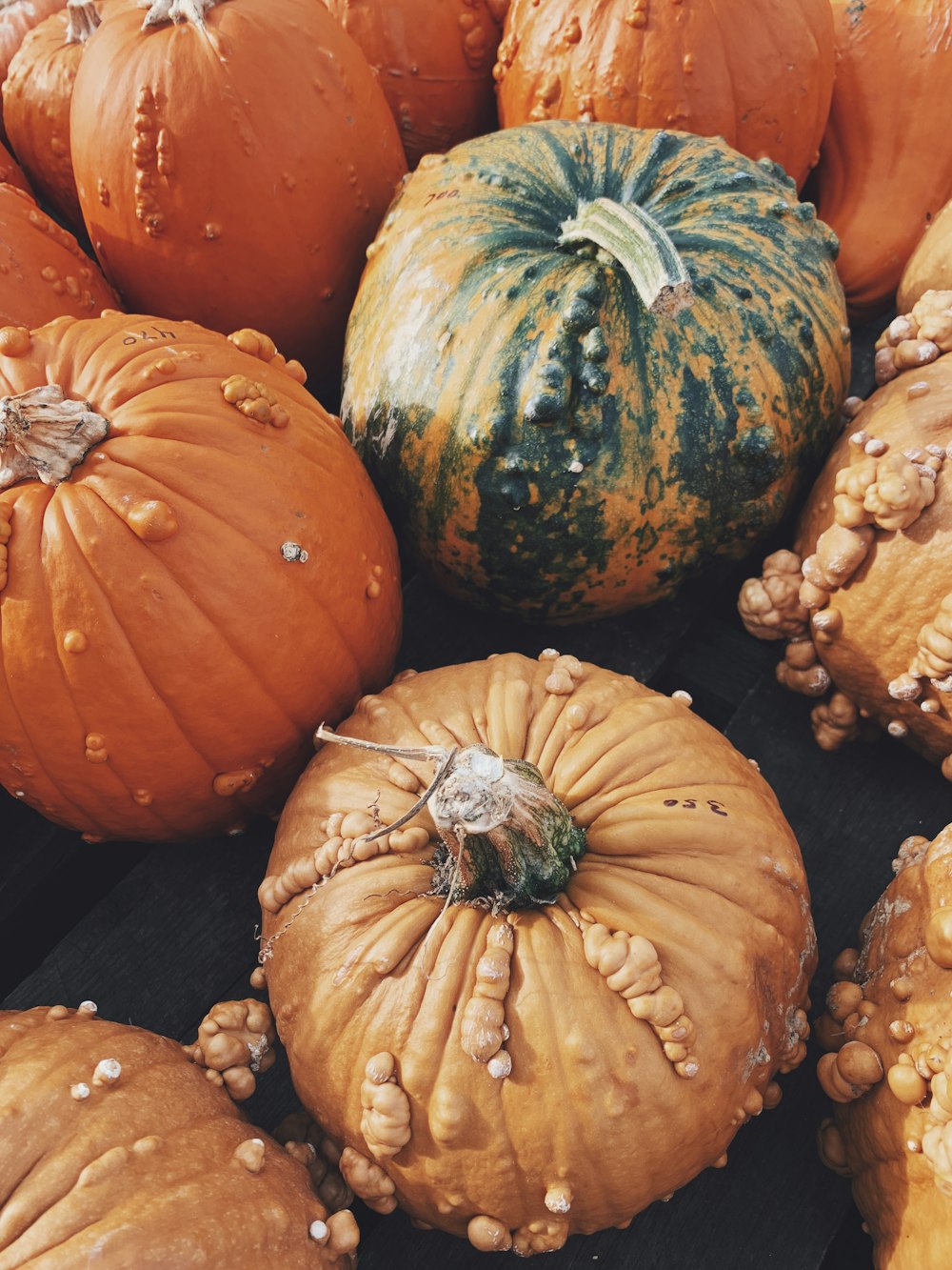 orange pumpkins on brown wooden table