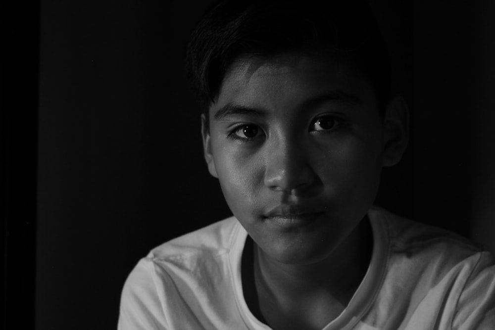 grayscale photo of boy in crew neck shirt