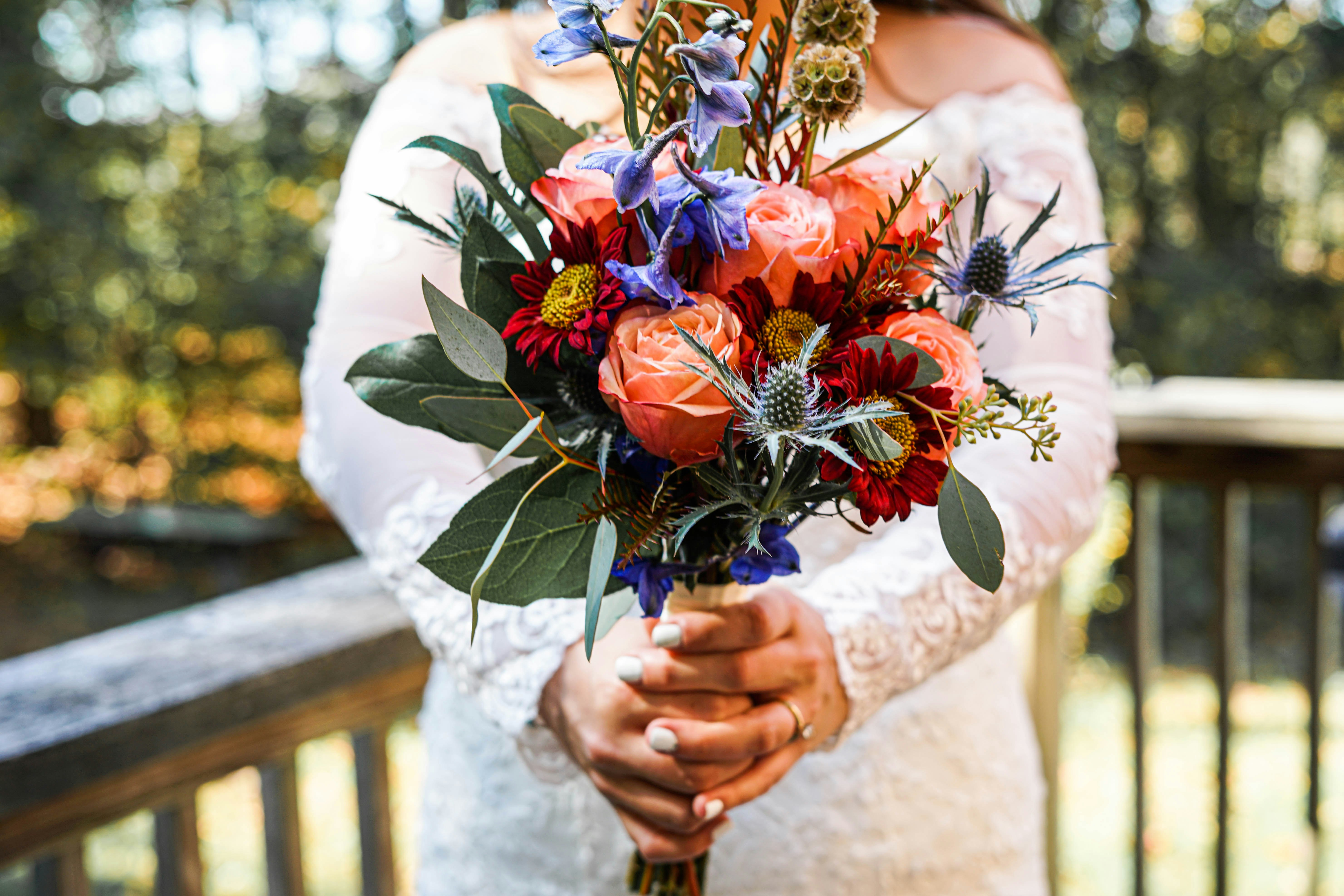 woman holding bouquet of flowers