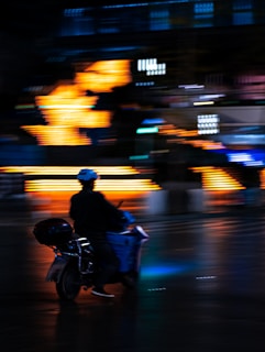 A dynamic shot of an electric scooter speeding through an urban street at sunset