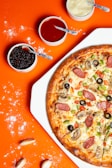 pizza with pepperoni and cheese on orange table
