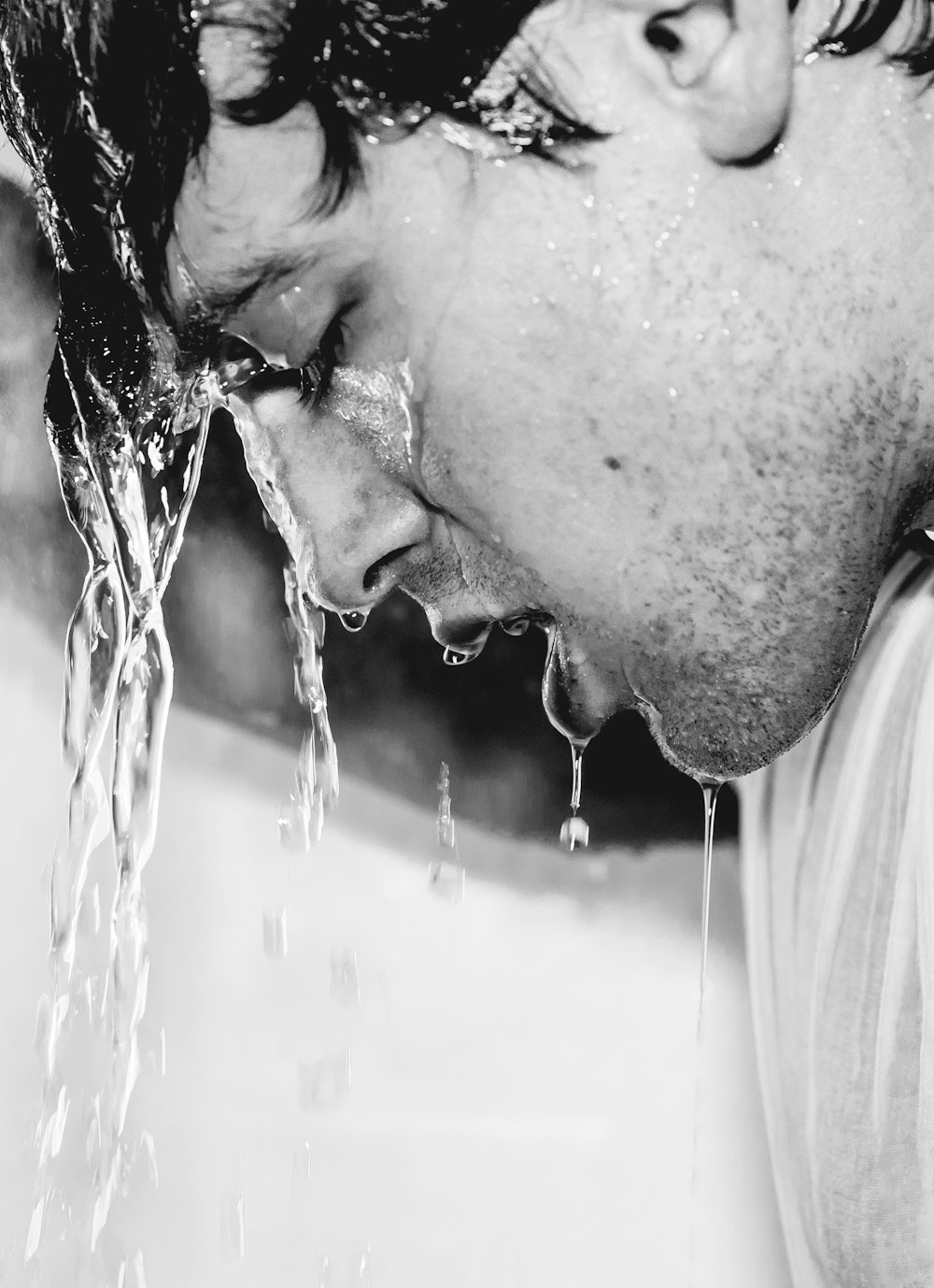 man in white shirt with water droplets