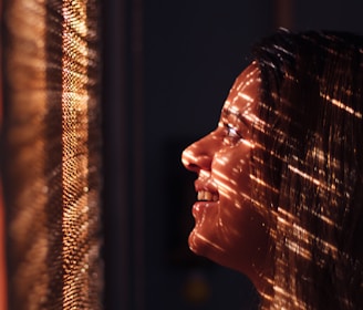 woman with brown hair looking at the light