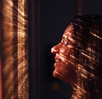 woman with brown hair looking at the light