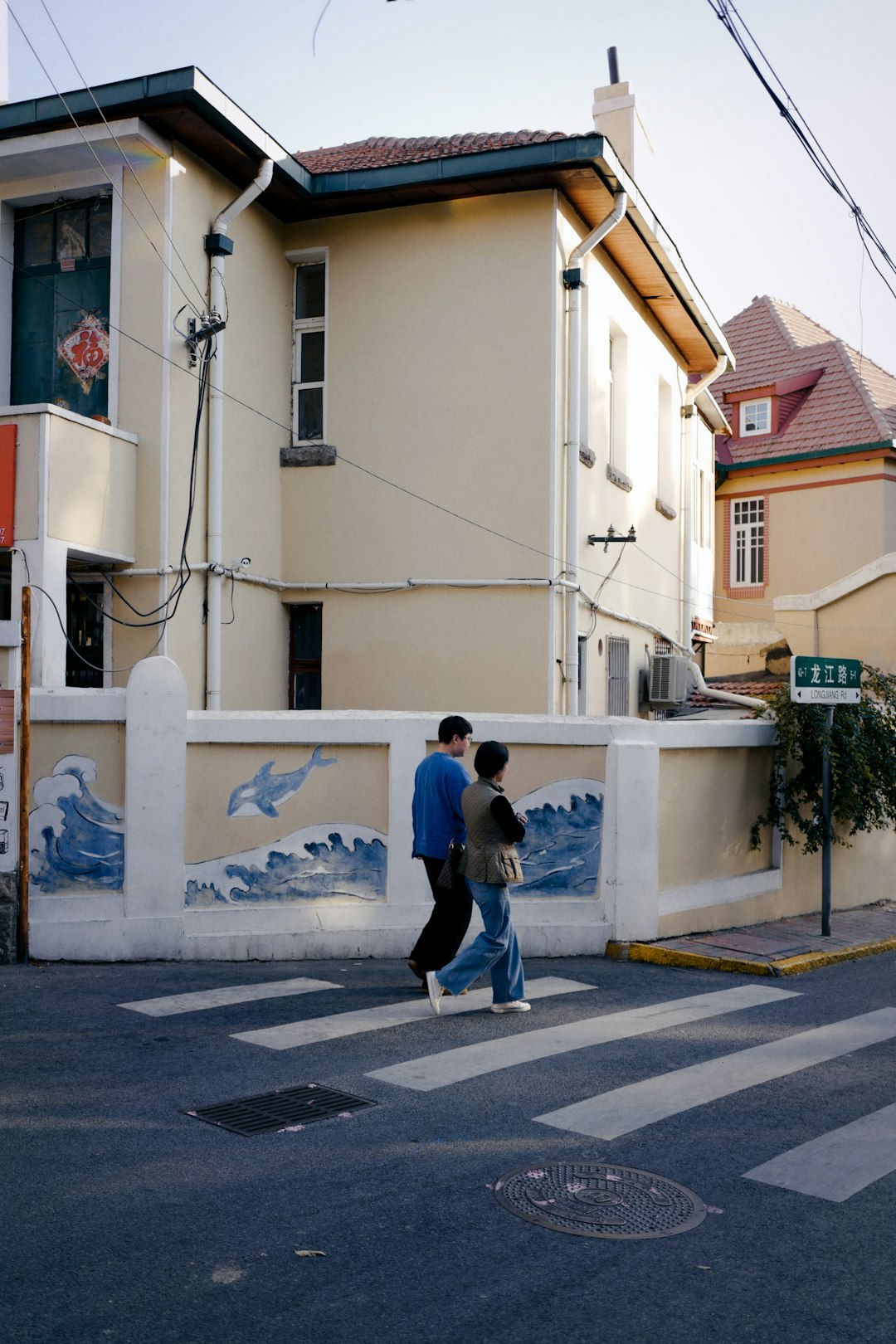 man in black jacket walking on sidewalk during daytime