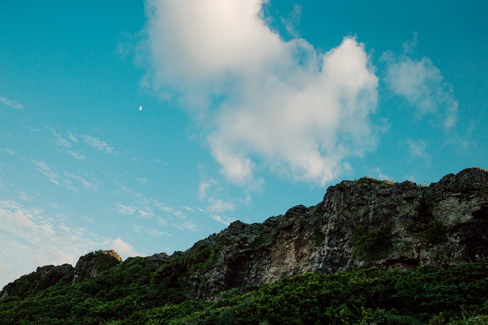 green and brown mountain under blue sky and white clouds during daytime