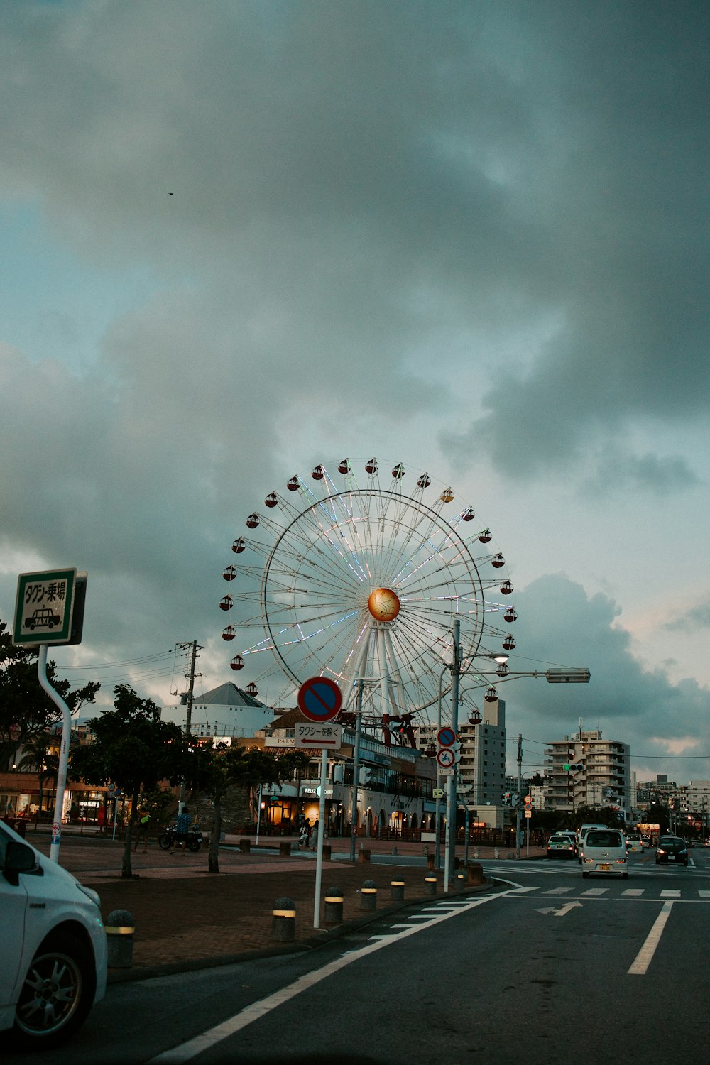 ferris wheel near city buildings during night time