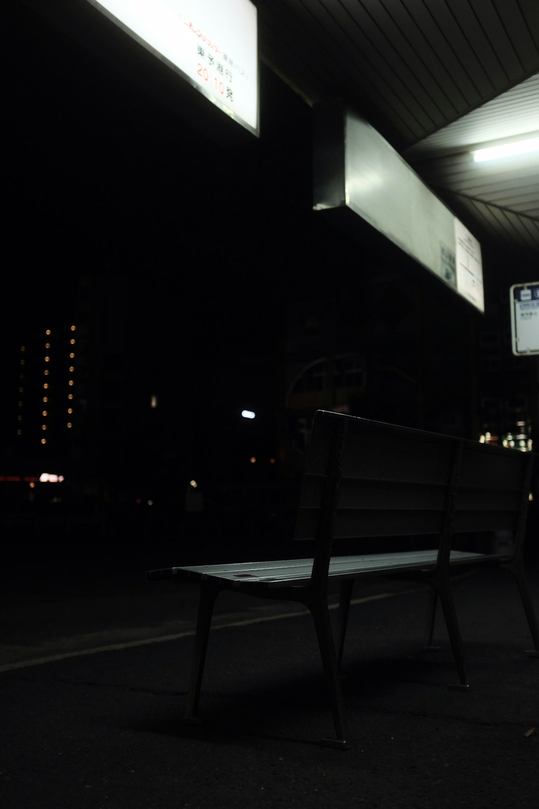 black metal bench near white light post during night time