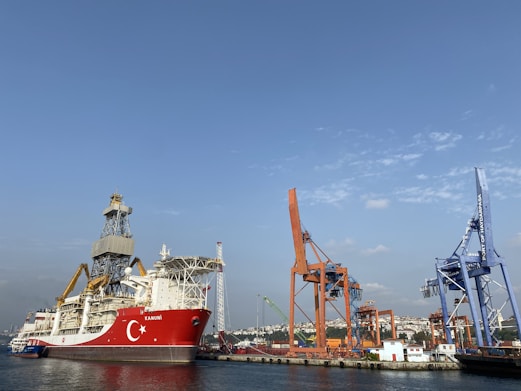 red and white ship on sea during daytime
