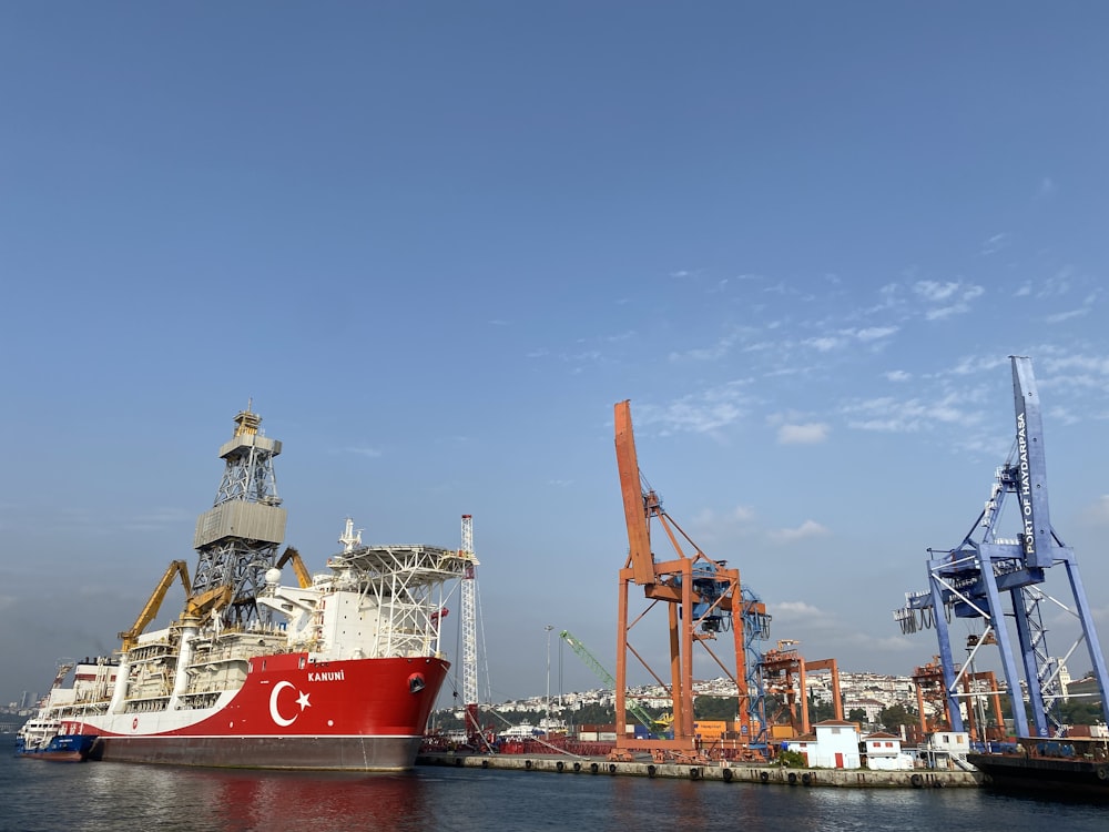 red and white ship on sea during daytime