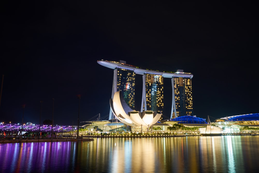 white and brown concrete building near body of water during nighttime