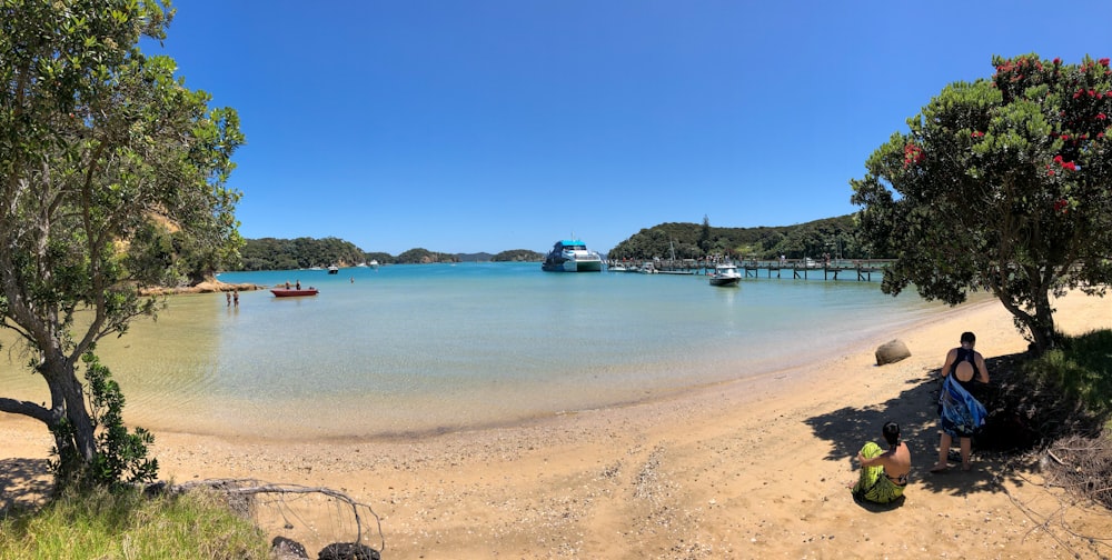 white boat on sea shore during daytime