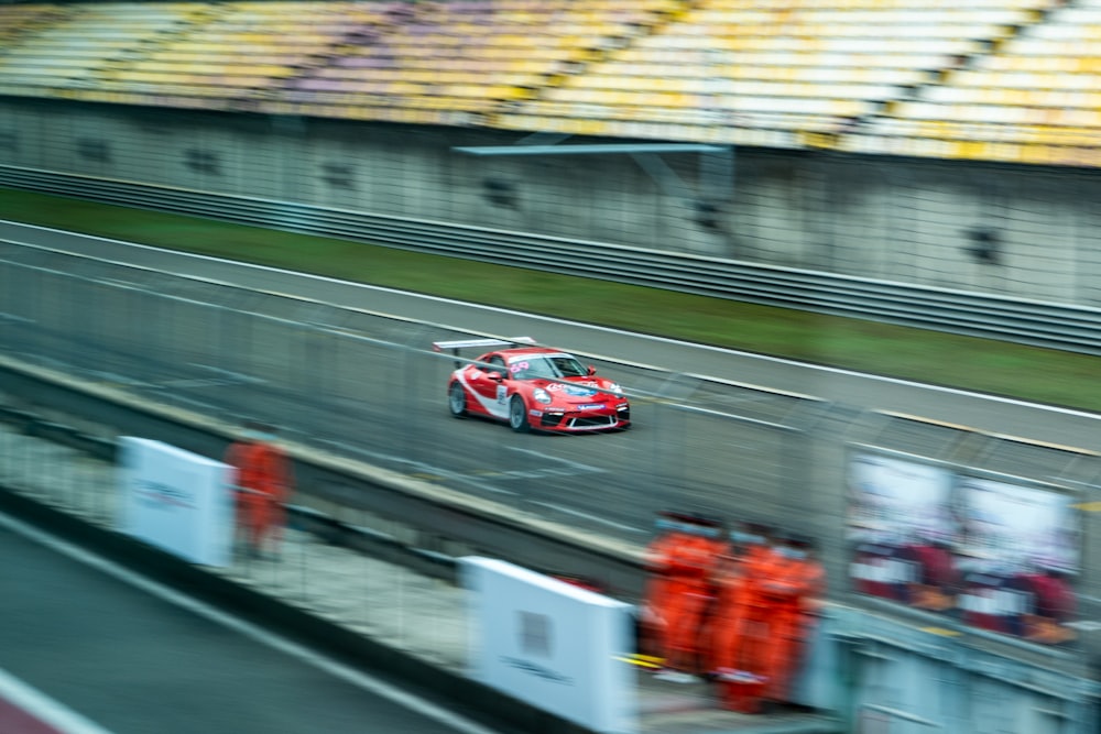 red and white racing car on track