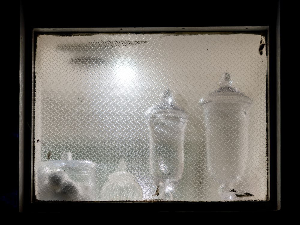 clear glass bottles on brown wooden table