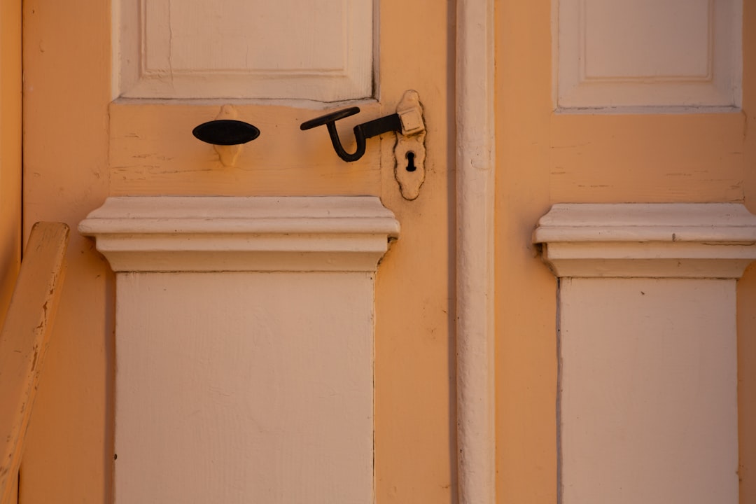 white wooden door with black steel door lever