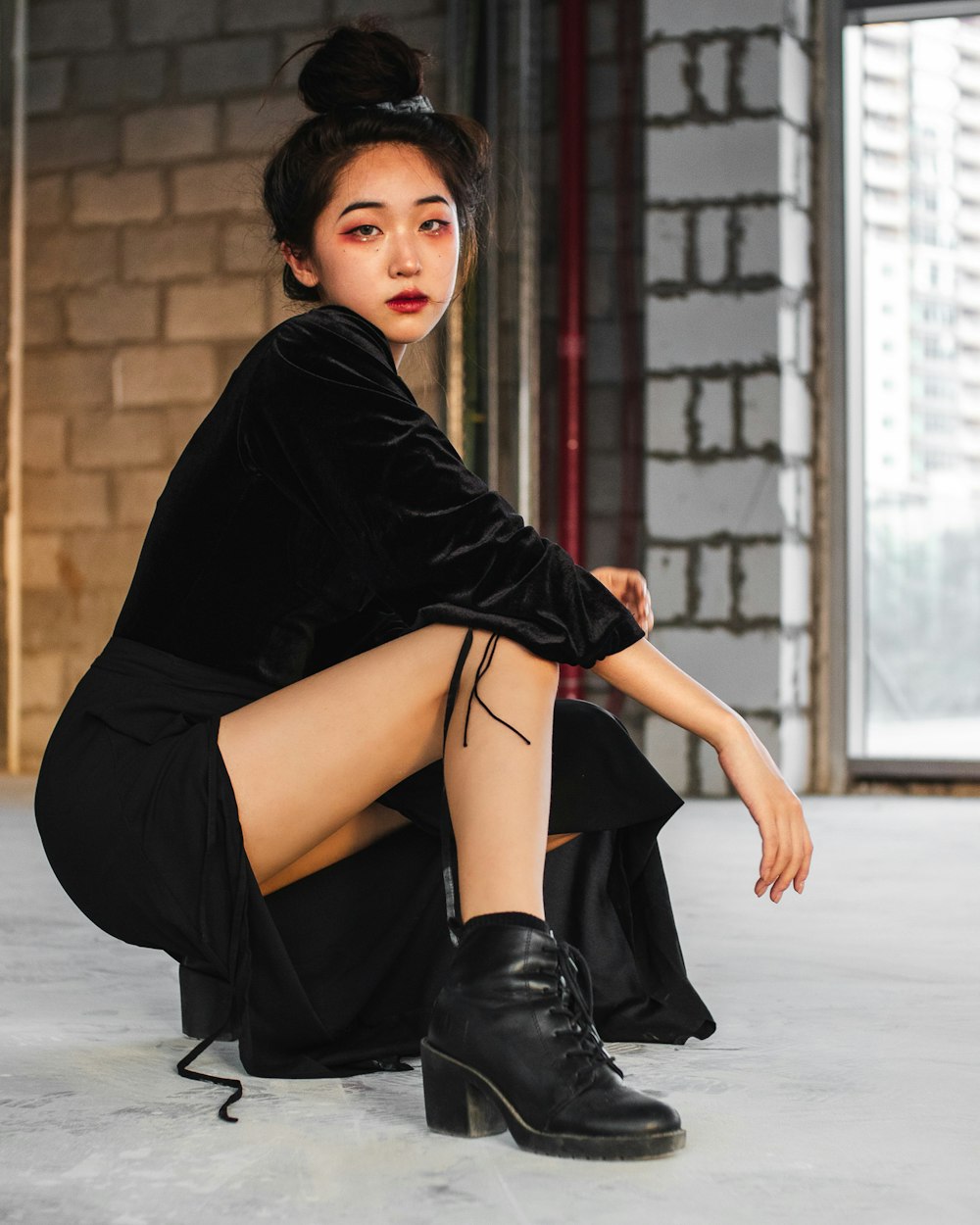 woman in black dress sitting on floor