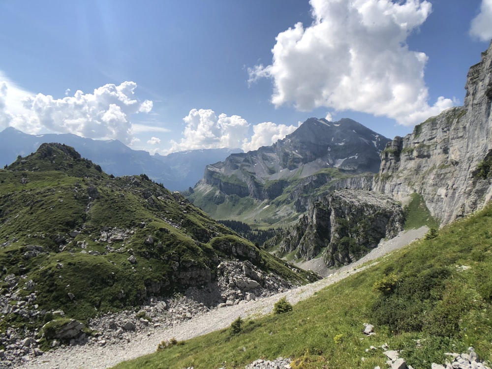 green and gray mountains under blue sky and white clouds during daytime