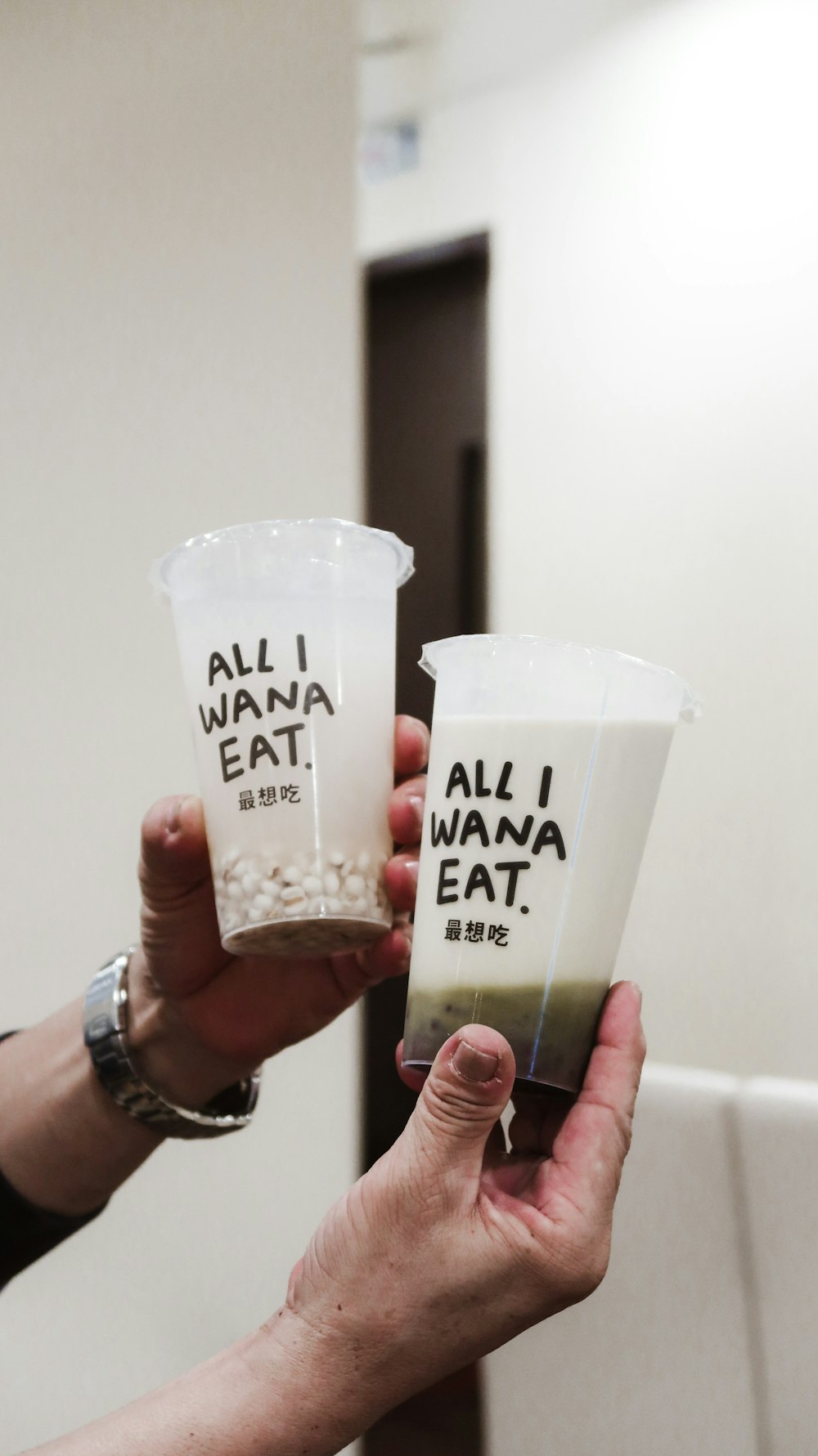 person holding white plastic cup