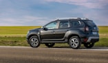 black suv on gray asphalt road during daytime