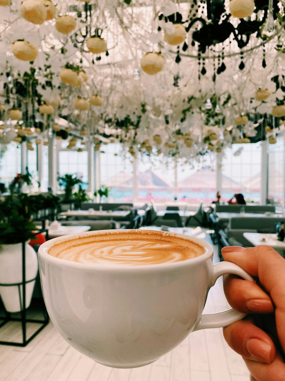 white ceramic cup with brown liquid