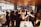 A group of business professionals celebrating success in a modern office.