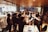 A group of business professionals celebrating success in a modern office.