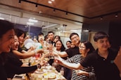 A team celebrating success with smiles and high-fives in a vibrant workplace.