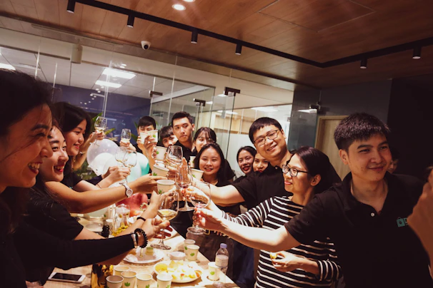 A smiling team celebrating a successful customer service training session in a warm, elegant office space.