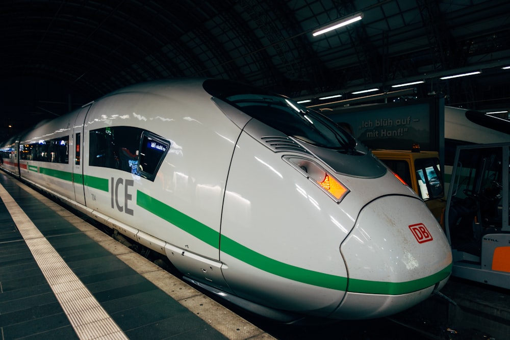 white and green train on train station