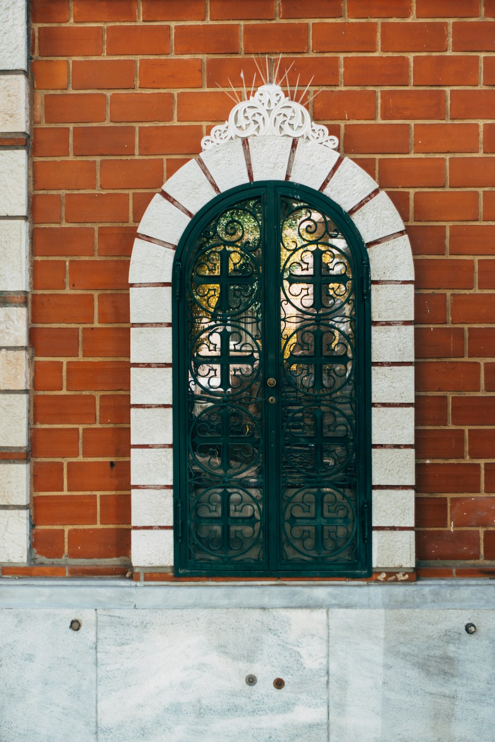 black wooden door on brown brick wall