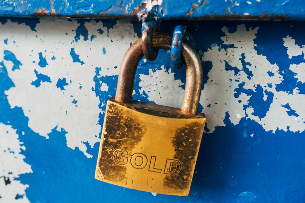 gold padlock on blue and white floral door