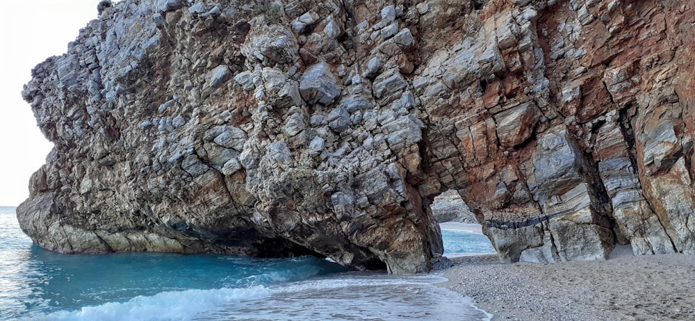 brown rock formation on blue sea during daytime