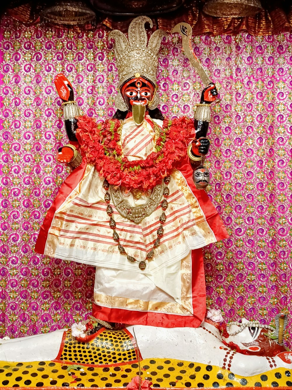 gold and red dress on pink and white textile